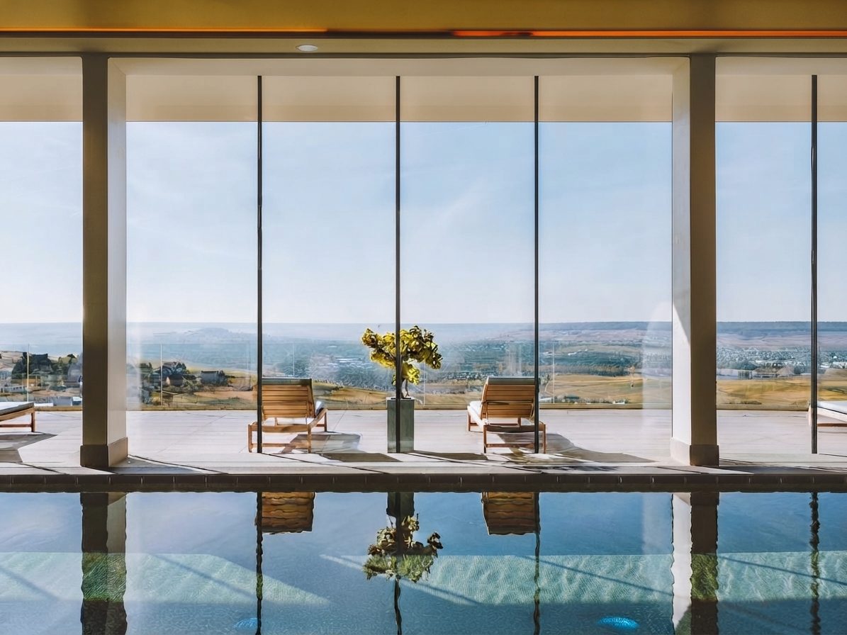 Piscine intérieure du spa de 1 500 m² du Royal Vallée, baies vitrées sur la vallée de la Marne (51)